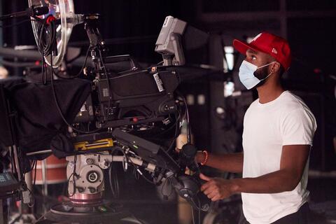 Dejon Sullivan works a large camera