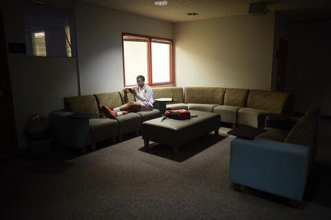 Marcus Haynes studying on a couch