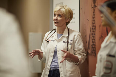 doctor in hallway talking to residents