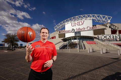 A man spins a basketball on his finger