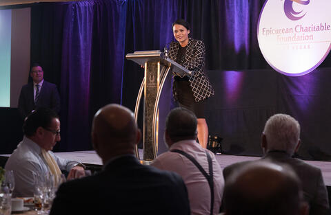 Martha Morales standing at a podium