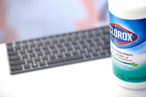 black keyboard with package of Clorox wipes in foreground
