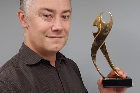 man with award