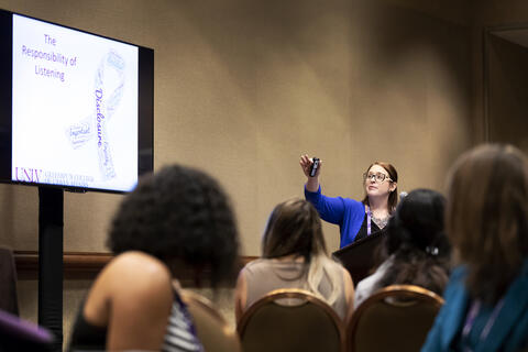 woman presenting at conference