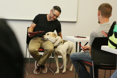 man in meeting with dog