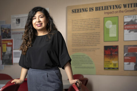 woman in front of posters