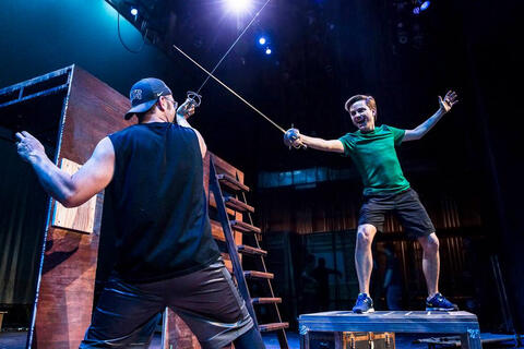 Two students practice swordfighting