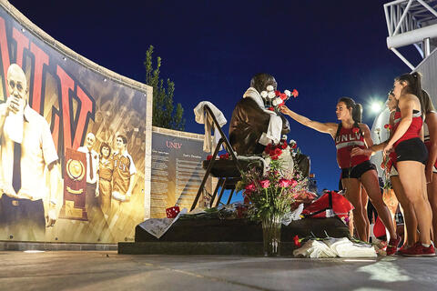 U.N.L.V. dancers place flowers on the Jery Tarkanian statue
