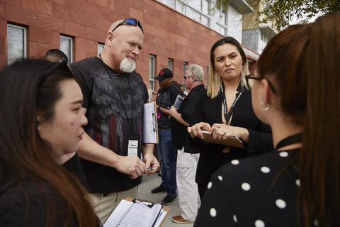 Jim Stelk talks to three students during the Urban Adventure class.