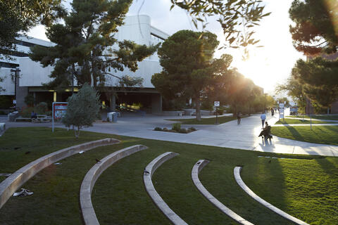 Campus scene at desk with person using wheelchair in distance