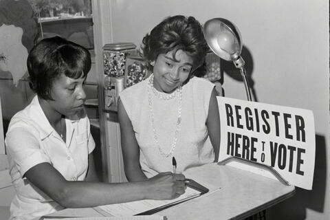 Two women look over paperwork