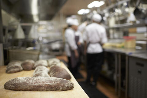 commercial kitchen with chefs working in background