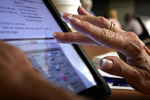 Fingers scrolling on a tablet