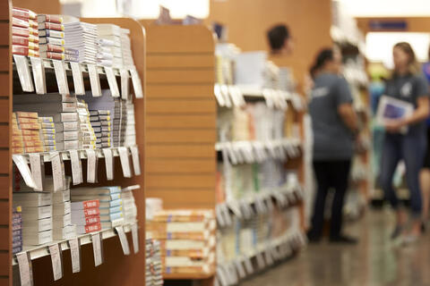 stacks of textbooks in campus bookstore