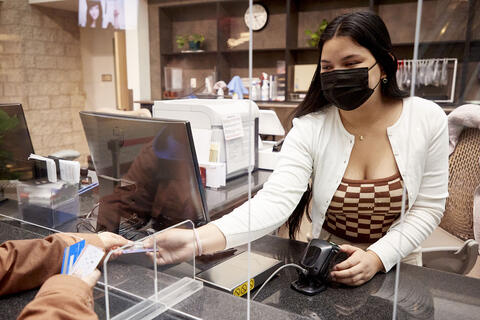 woman working at library checkout counter