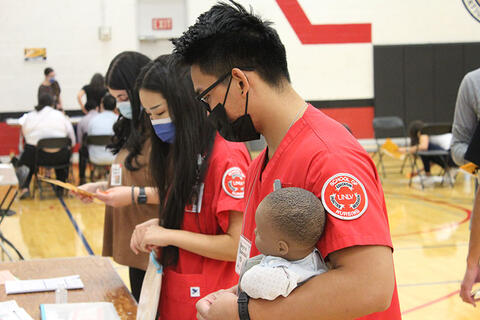 Two nursing students looking at a table