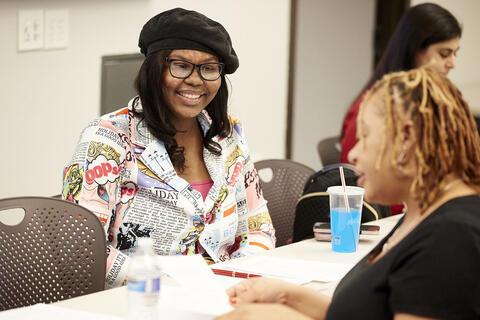 two women talking in classroom setting