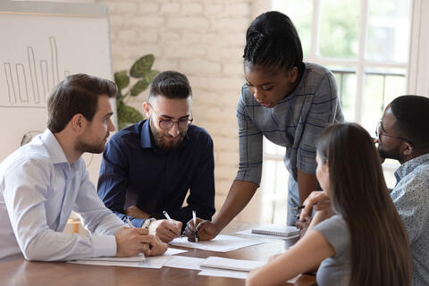 People collaborating at a table.