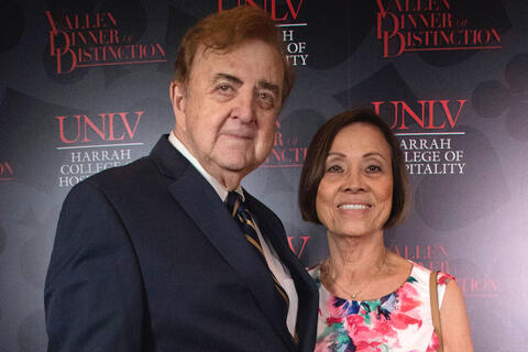 man and woman posing at event