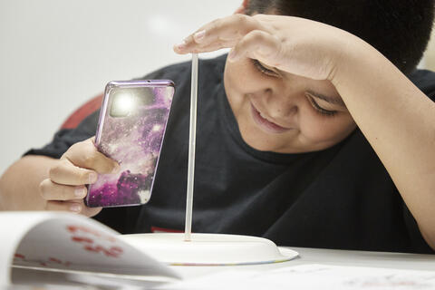 Young student doing science experiment