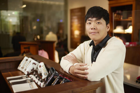 man posing in golf shop
