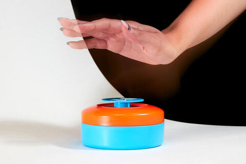 hand about to press on game buzzer