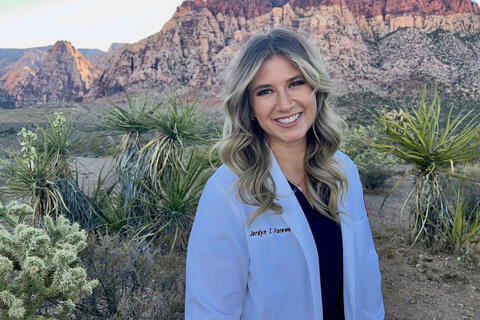 woman in doctor's coat outdoors