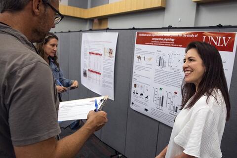 Carla Madelaire smiles as she gives a presentation.