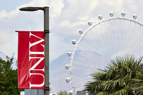 U.N.L.V. banner with the High Roller carousel in the background