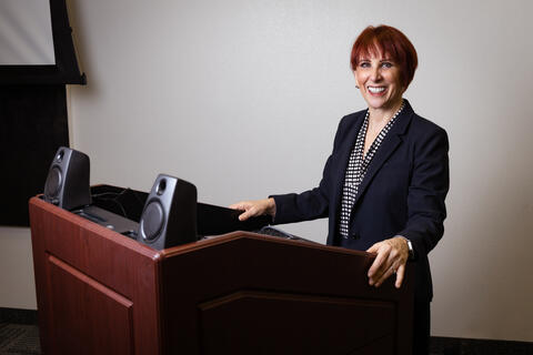 woman smiling behind podium