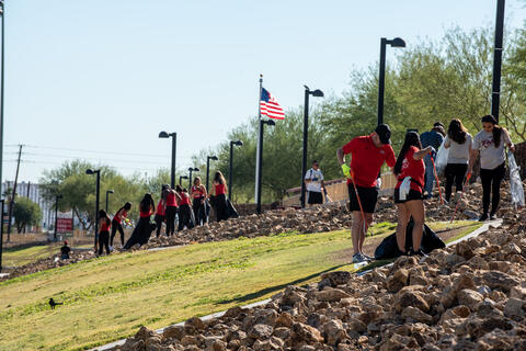 group of volunteers cleaning a park