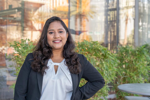 international student poses for photo outside