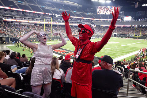 Scarlet and Gray, “REB's Glitter Squad”, Lester Cruz and Isabel Ferguson, take pictures and hype up students and families during the October 2022 homecoming football game.