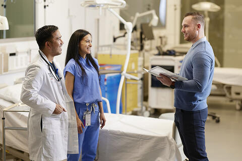 Healthcare administrator talking to two doctors