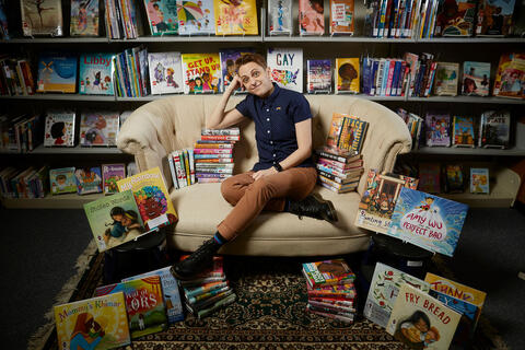 person seated on couch in library