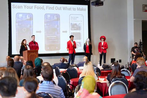 student group gives presentation in front of crowd