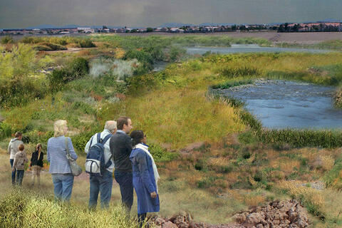 People standing in a grass field with puddles of water