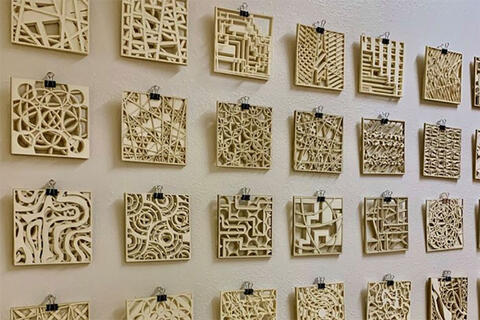 An art exhibition featuring squares of various shapes on the wall