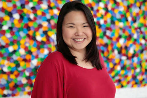 woman posing in front of colorful background