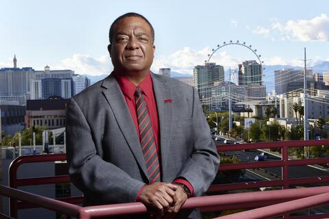 man behind railing with Las Vegas Strip in background