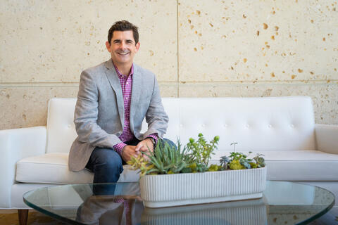 man sitting on white sofa