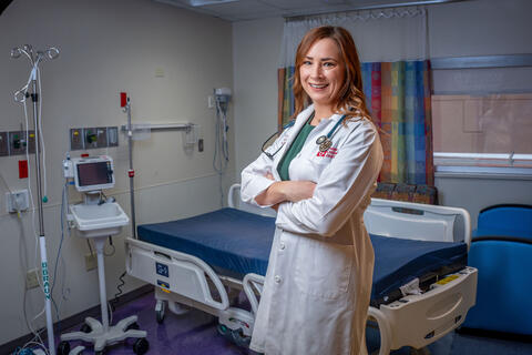 woman in white medical lab coat standing in exam room