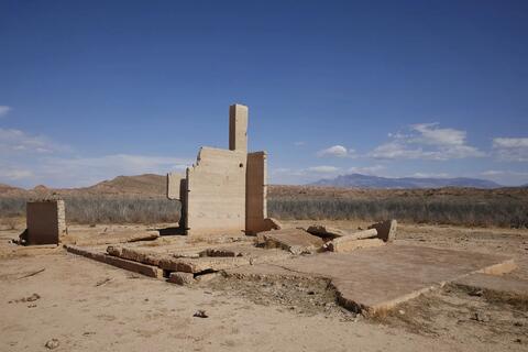 sandstone colored structure against a clear blue sky