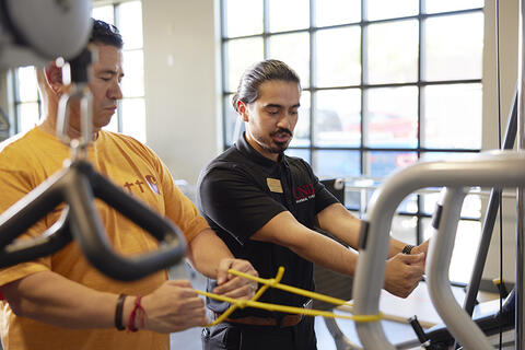 instructor showing arm exercise for therapy