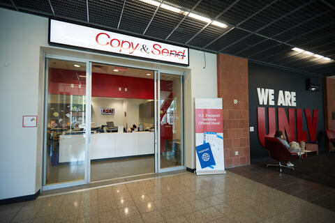 The front of Rebel Copy &amp; Send in the Student Union, with a banner that says "U.S. Passport Services Offered Here"