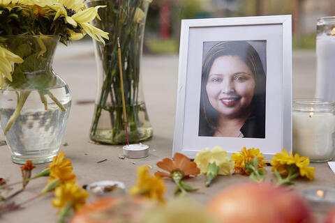 framed photo of woman at vigil