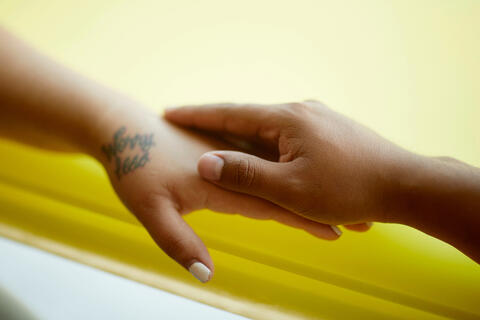 Two hands comforting each other.