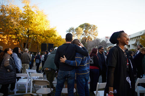 Two people embracing each other at the December 6 vigil