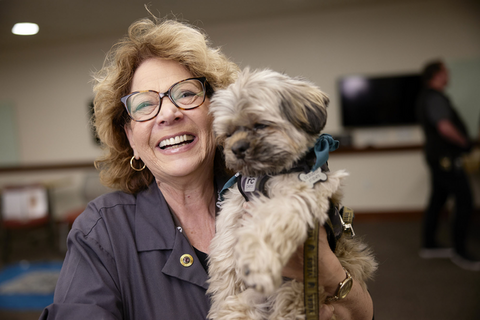 closeup of woman holding her dog