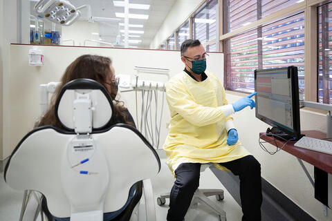 A dentist talking with a patient about their results